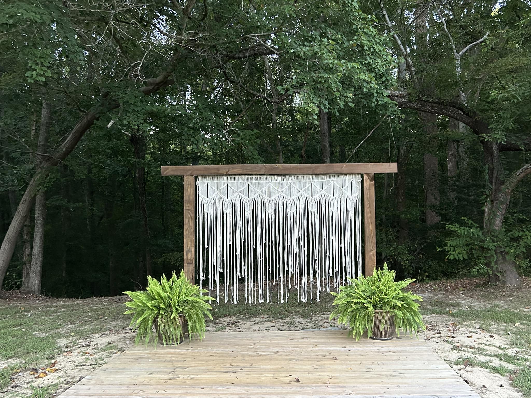 385066567_302377792602200_5221550024016250739_n wedding arch with macrame hanging and ferns